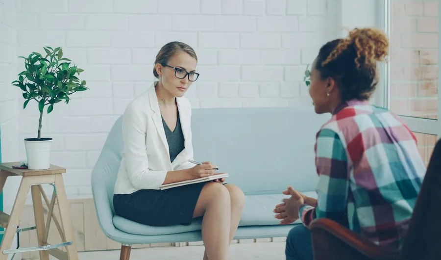 A counsellor listening to a client during a session