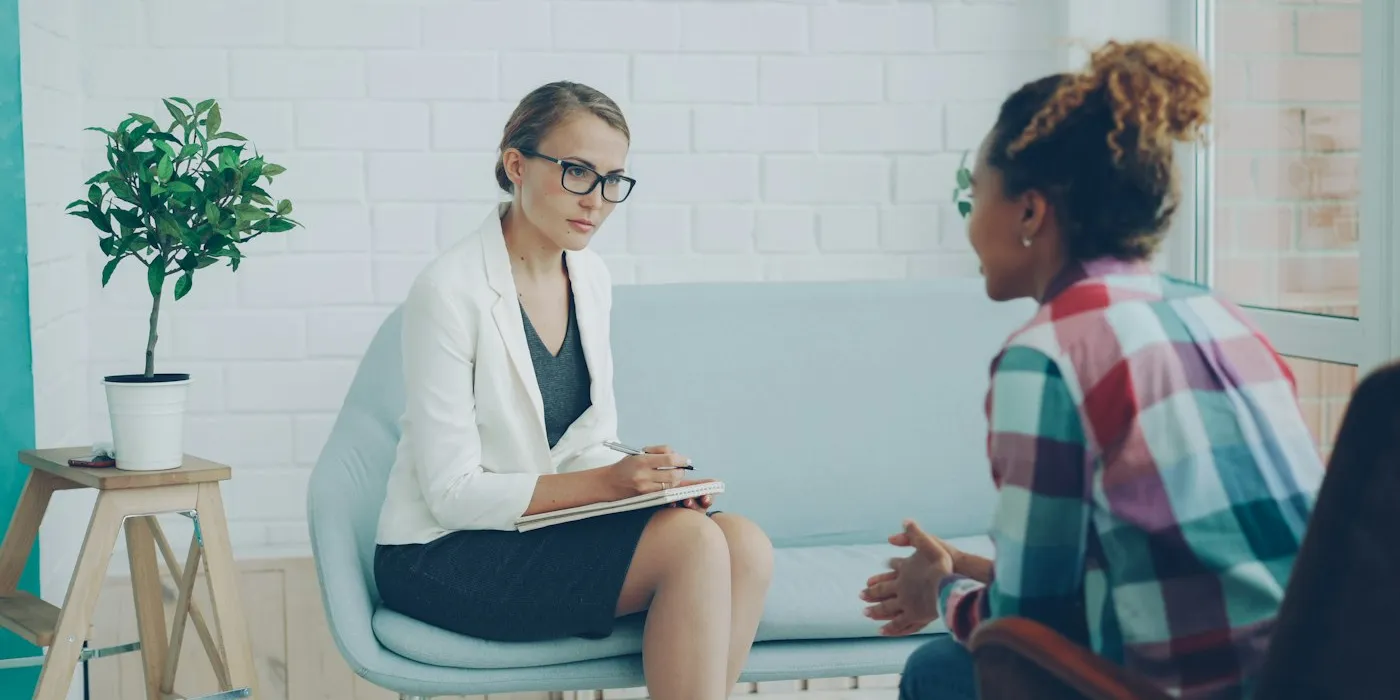 A counsellor listening to a client during a session